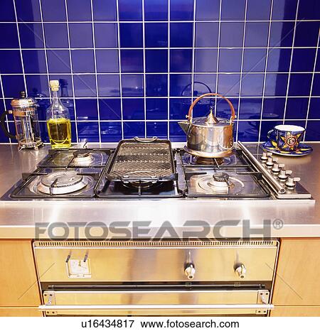 Blue ceramic wall tiles above stainless steel gas hob with steel kettle View Large Photo Image Stock Photo - Blue ceramic wall tiles above stainless steel gas hob with steel kettle. Fotosearch