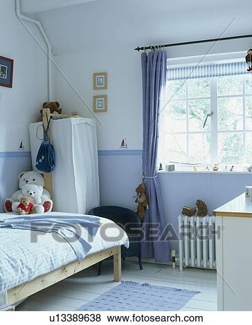 Blue curtain at window in child's blue+white bedroom View Large Photo Image Stock Photo - Blue curtain at window in child's blue+white bedroom. Fotosearch