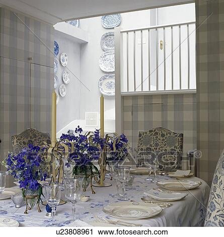 Blue delphiniums on table in small dining room with blue checked wallpaper View Large Photo Image Stock Image - Blue delphiniums on table in small dining room with blue checked wallpaper. Fotosearch