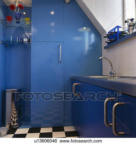 Blue fitted storage unit in modern blue kitchen View Large Photo Image Stock Photograph - Blue fitted storage unit in modern blue kitchen. Fotosearch