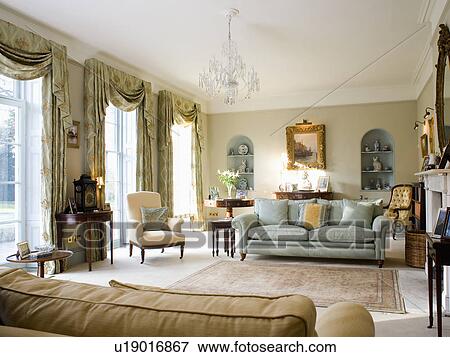 Blue-green sofa in country drawing room with swagged curtains View Large Photo Image Stock Photo - Blue-green sofa in country drawing room with swagged curtains. Fotosearch