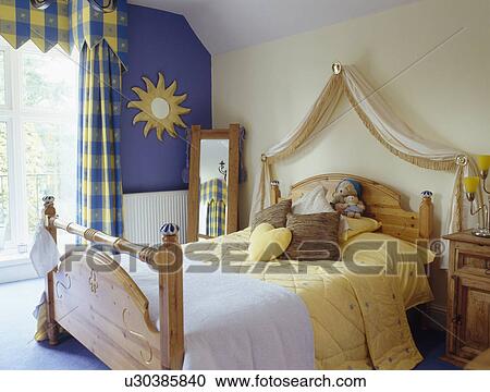 Blue+yellow checked curtains and pine bed with yellow bedlinen in small bedroom View Large Photo Image Stock Image - Blue+yellow checked curtains and pine bed with yellow bedlinen in small bedroom. Fotosearch