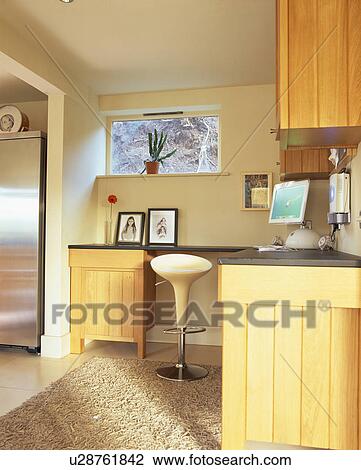 Bomba stool at fitted unit with computer in home office in corner of modern kitchen View Large Photo Image Stock Image - Bomba stool at fitted unit with computer in home office in corner of modern kitchen. Fotosearch