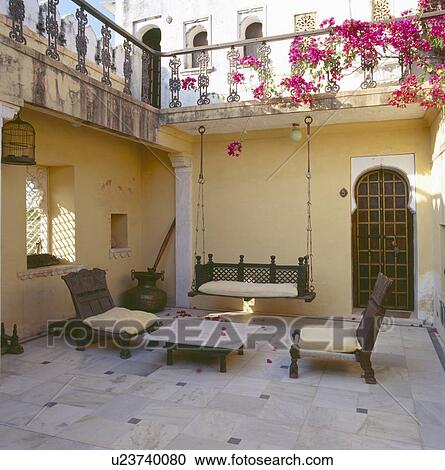 Stock Image - Bougainvillea on courtyard balcony in 17th century fortress now a hotel in the Aravalli Hills. Fotosearch