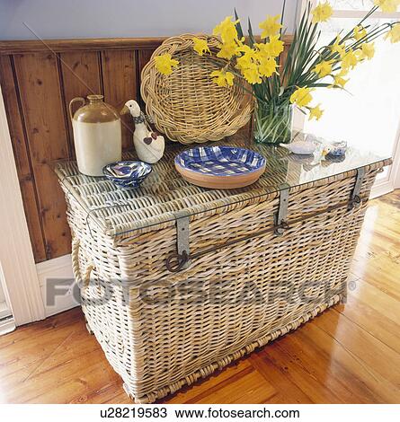 Bowls and vase of daffodils on large wicker chest View Large Photo Image Stock Image - Bowls and vase of daffodils on large wicker chest. Fotosearch