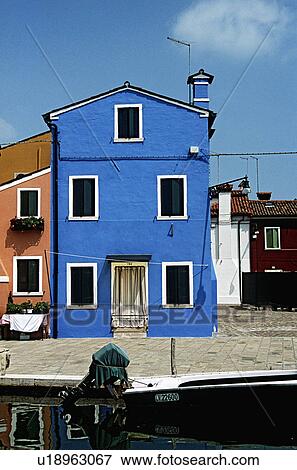 Stock Photo - Bright blue house beside canal in Venice&#10;. Fotosearch