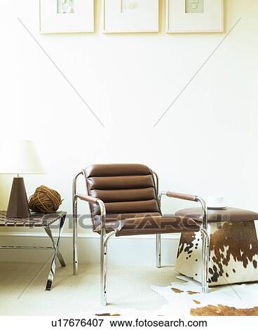 Stock Photo - Brown leather and chrome chair in modern white living room. Fotosearch