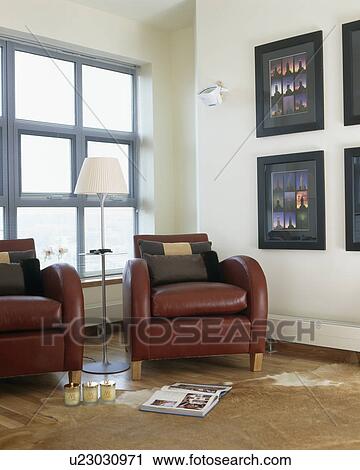 Brown leather armchairs in front of large window in modern white living room View Large Photo Image Stock Image - Brown leather armchairs in front of large window in modern white living room. Fotosearch
