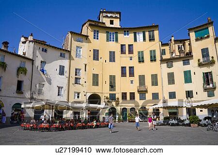 Stock Image - Buildings and people in Piazza Anfiteatro, Lucca, Tuscany, Italy. Fotosearch