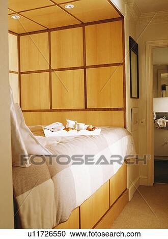 Stock Image - Built-in bed with television in storage in modern bedroom. Fotosearch
