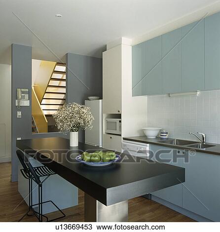 Built-in black table in modern kitchen with pastel blue fitted units View Large Photo Image Stock Image - Built-in black table in modern kitchen with pastel blue fitted units. Fotosearch