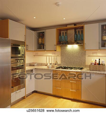 Bulthaup double oven in modern white kitchen with granite splashback above hob View Large Photo Image Stock Photo - Bulthaup double oven in modern white kitchen with granite splashback above hob. Fotosearch