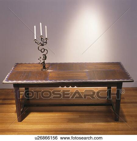 Candelabra on old wooden table on wooden hall floor View Large Photo Image Stock Photograph - Candelabra on old wooden table on wooden hall floor. Fotosearch
