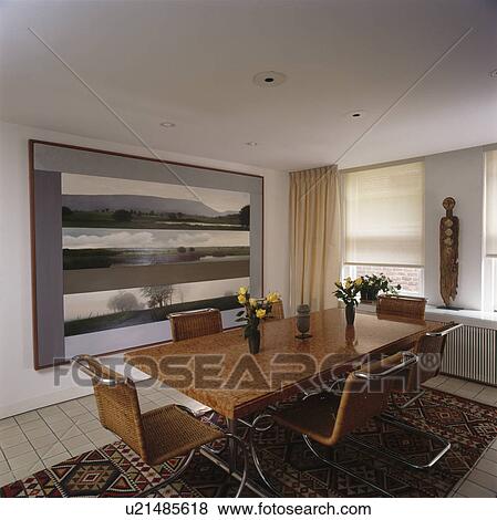 Cane and chrome chairs with walnut table in modern dining room View Large Photo Image Stock Photo - Cane and chrome chairs with walnut table in modern dining room. Fotosearch