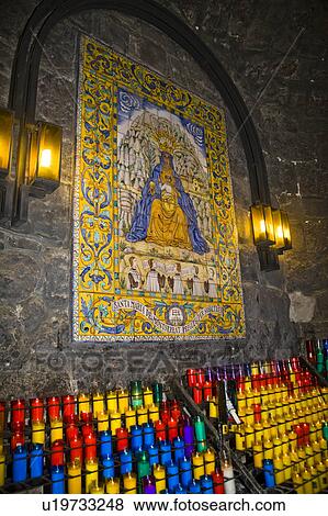 Stock Photo - Ceramic tiled panel and candles inside Montserrat Basilica, Montserrat, near Barcelona, Spain. Fotosearch