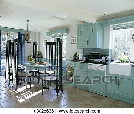 Stock Image - Charles Rennie Mackintosh-style chairs in turquoise kitchen dining room. Fotosearch