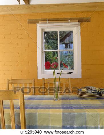 Checked cloth on table in front of window in dining room with brick walls painted orange View Large Photo Image Stock Image - Checked cloth on table in front of window in dining room with brick walls painted orange. Fotosearch