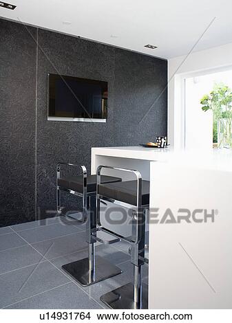 Picture - Chrome and black stools at breakfast bar in black and whtie kitchen. Fotosearch
