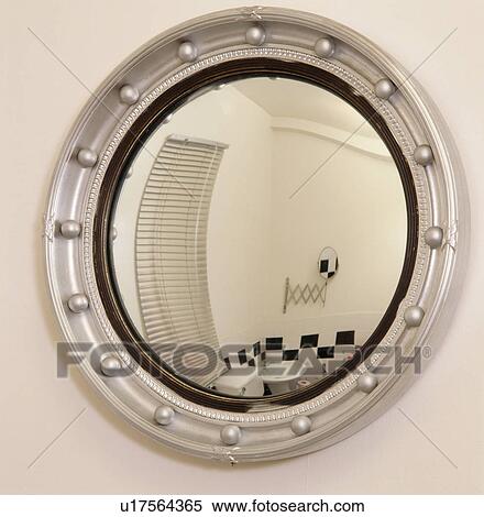 Stock Photography - Circular metallic mirror with reflection of bathroom. Fotosearch
