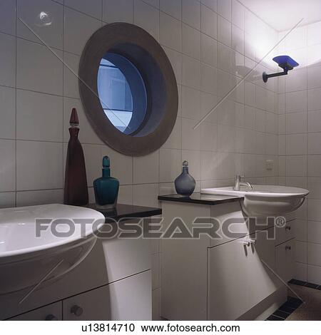 Circular window in modern white tiled bathroom with double basins View Large Photo Image Stock Image - Circular window in modern white tiled bathroom with double basins. Fotosearch