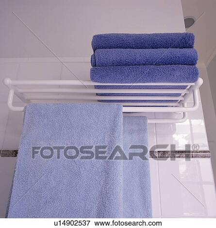 Cloe-up of blue towels on white storage rack View Large Photo Image Stock Photo - Cloe-up of blue towels on white storage rack. Fotosearch