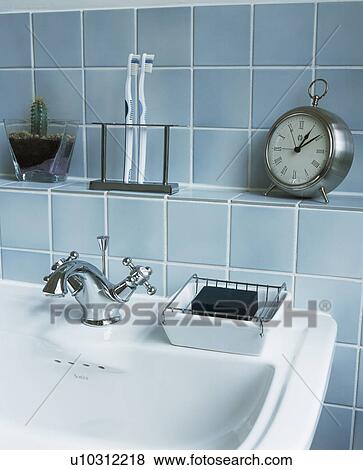 Close-up of alarm clock on blue tiled wall above bath View Large Photo Image Stock Photo - Close-up of alarm clock on blue tiled wall above bath. Fotosearch