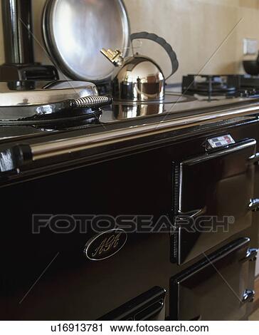 Stock Image - Close-up of Alessi kettle on black Aga oven. Fotosearch