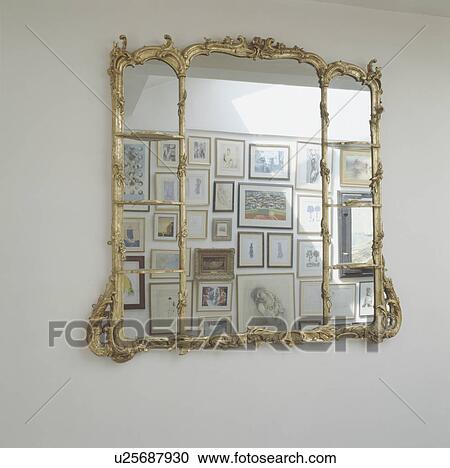 Close up of antique gilt mirror with reflection of pictures View Large Photo Image Stock Image - Close up of antique gilt mirror with reflection of pictures. Fotosearch