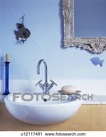 Stock Image - Close-up of basin in blue traditional bathroom. Fotosearch
