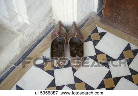 Close-up of beaded Rajastani slippers on marble tiled floor View Large Photo Image Stock Photo - Close-up of beaded Rajastani slippers on marble tiled floor. Fotosearch