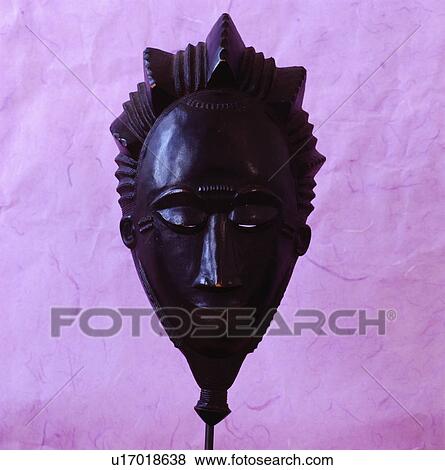 Stock Photo - Close-up of black carved wooden mask. Fotosearch