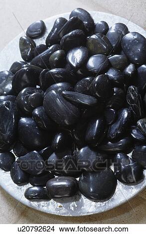 Close-up of black pebbles on metal plate View Large Photo Image Picture - Close-up of black pebbles on metal plate. Fotosearch