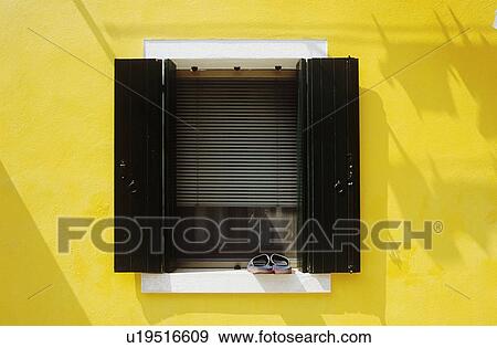 Close up of black shutters and slatted blind on window of yellow Venetian house
 View Large Photo Image Stock Photo - Close up of black shutters and slatted blind on window of yellow Venetian house
. Fotosearch