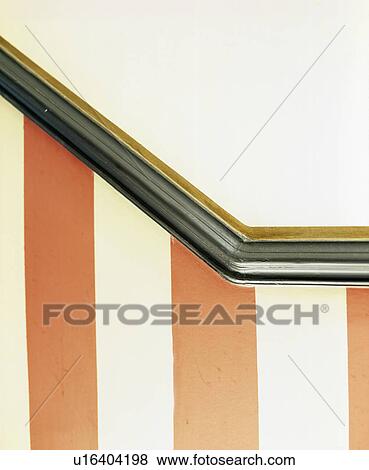 Close-up of black wood dado rail above wall painted with orange and cream stripes View Large Photo Image Stock Photo - Close-up of black wood dado rail above wall painted with orange and cream stripes. Fotosearch