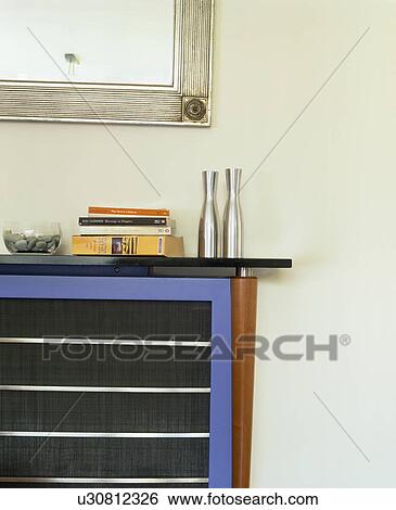 Stock Photograph - Close-up of blue and black console table in modern white living room. Fotosearch