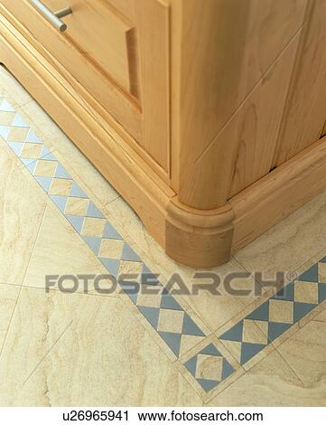 Stock Image - Close-up of blue and cream ceramic floor tiles. Fotosearch