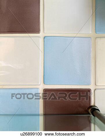 Stock Image - Close-up of blue and cream ceramic wall tiles. Fotosearch