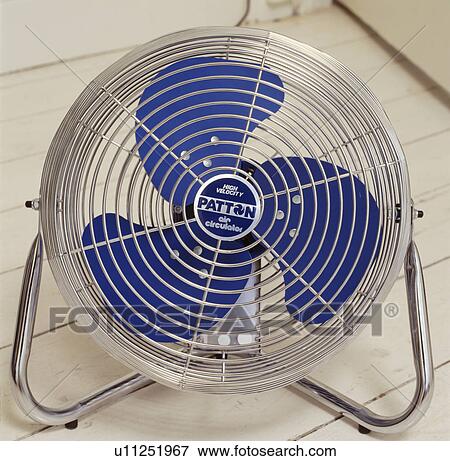 Stock Photo - Close-up of blue and steel portable electric fan. Fotosearch