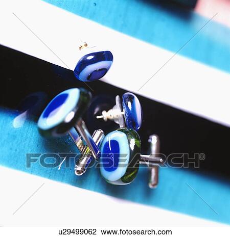 Stock Image - Close-up of blue glass cuff-links. Fotosearch