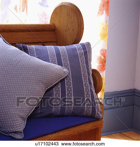 Close-up of blue striped cushion on wooden settle View Large Photo Image Stock Image - Close-up of blue striped cushion on wooden settle. Fotosearch