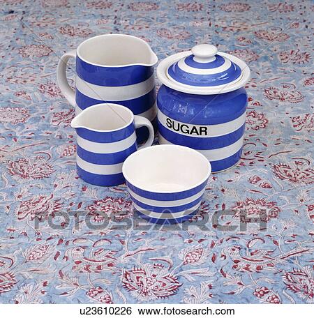 Stock Photograph - Close-up of blue+white striped Cornishware jugs and sugar jar. Fotosearch