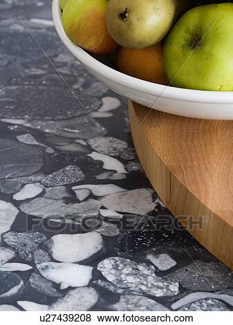 Stock Photo - Close-up of bowl of apples on patterned grey worktop. Fotosearch