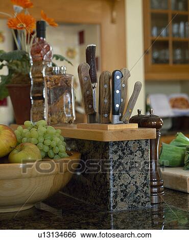 Close-up of bowl of fruit beside kitchen knife storage View Large Photo Image Stock Photograph - Close-up of bowl of fruit beside kitchen knife storage. Fotosearch