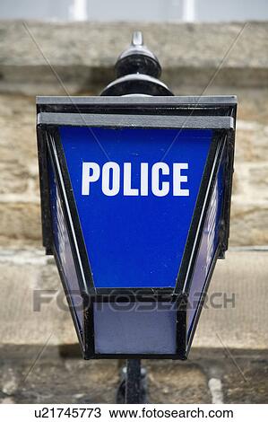 Stock Image - Close up of bright blue glass British Police lamp on wall&#10;. Fotosearch