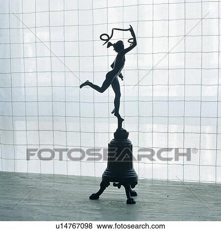 Stock Photo - Close-up of bronze statue of Eros on metal pedestal. Fotosearch