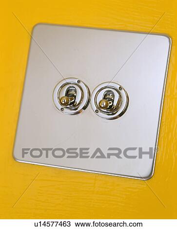 Stock Image - Close-up of brushed steel light switch. Fotosearch