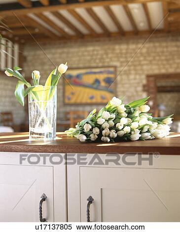 Close-up of bunch of cream tulips on cream kitchen unit with wooden worktop View Large Photo Image Stock Photography - Close-up of bunch of cream tulips on cream kitchen unit with wooden worktop. Fotosearch