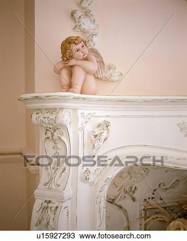 Close-up of cherub on ornate mantelpiece View Large Photo Image Stock Image - Close-up of cherub on ornate mantelpiece. Fotosearch