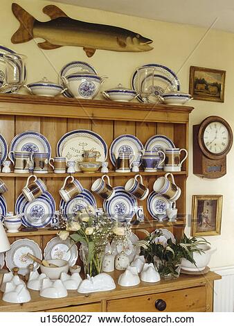 Stock Photo - Close-up of china collection and antique jelly moulds on pine dresser. Fotosearch