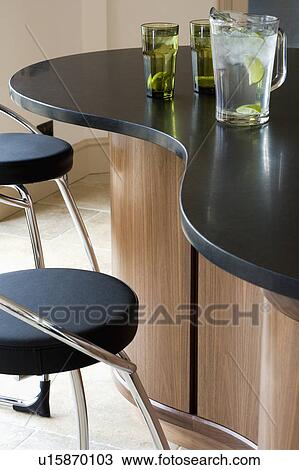 Close-up of chrome and black leather stools at breakfast bar with black granite worktop View Large Photo Image Stock Image - Close-up of chrome and black leather stools at breakfast bar with black granite worktop. Fotosearch